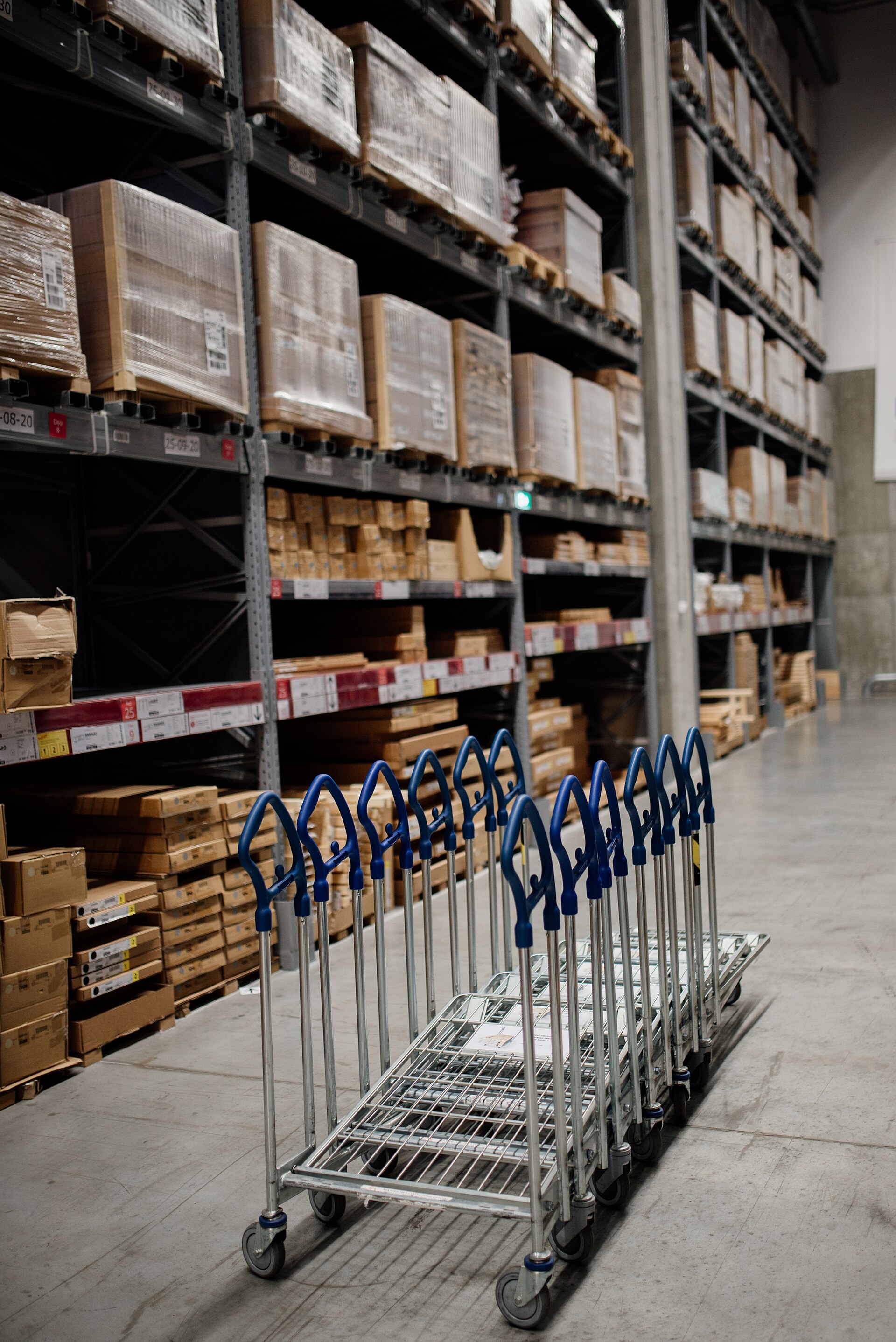Warehouse shelving with stock boxes and picking carts